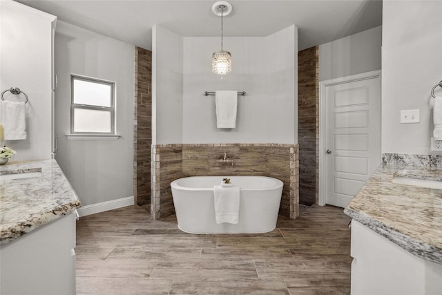 12756 Aspen Springs Ln, Fort Worth, TX 76052 - full bath featuring a soaking tub, vanity, tile walls, and wood finished floors