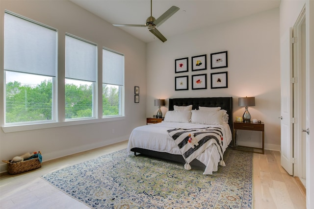bedroom with baseboards, wood finished floors, and a ceiling fan