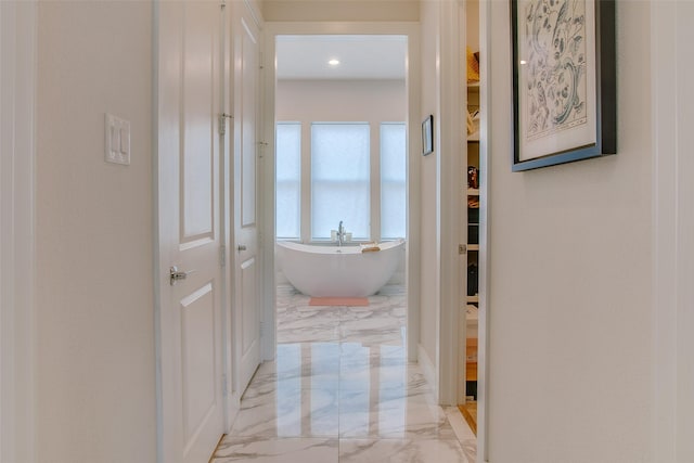 corridor with marble finish floor