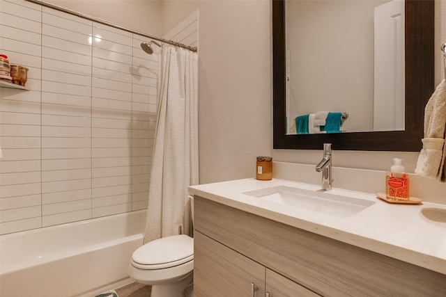 full bath with toilet, vanity, and shower / bath combo with shower curtain