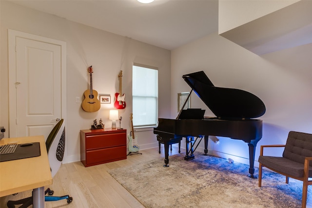 sitting room with baseboards and wood finished floors