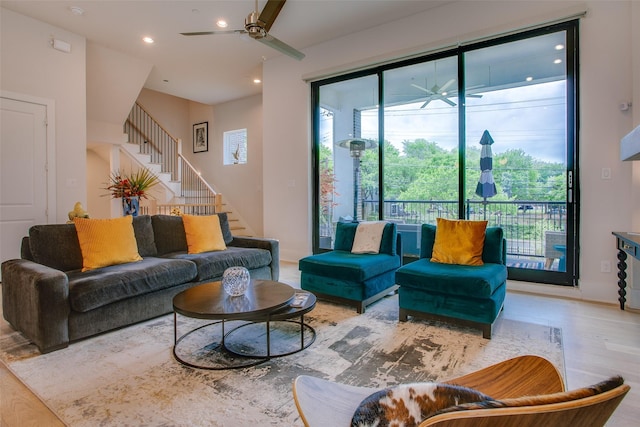 living area featuring stairs, recessed lighting, baseboards, ceiling fan, and wood finished floors