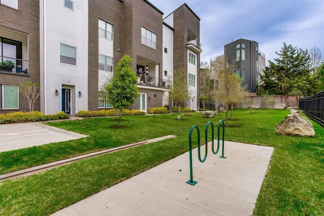 view of community with fence and a yard
