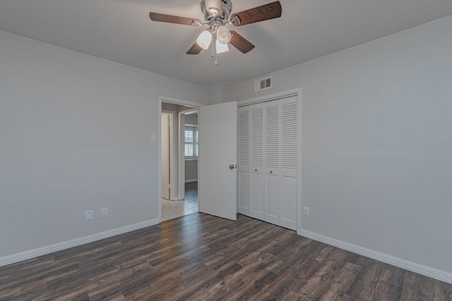3336 Whitehall Dr, Dallas, TX 75229 - unfurnished bedroom featuring baseboards, wood finished floors, a closet, and ceiling fan