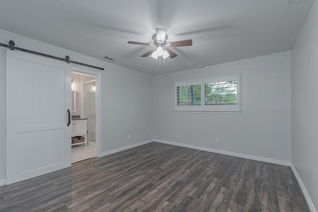 3336 Whitehall Dr, Dallas, TX 75229 - empty room featuring a barn door, dark wood-style floors, ceiling fan, and baseboards