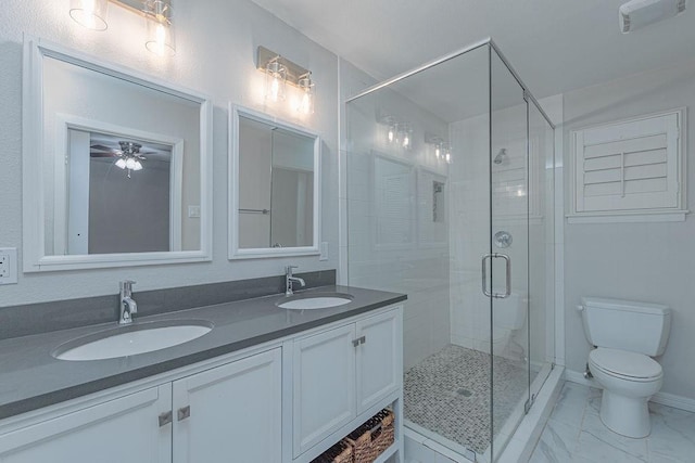 3336 Whitehall Dr, Dallas, TX 75229 - bathroom featuring a shower stall, double vanity, toilet, ceiling fan, and marble look tiles
