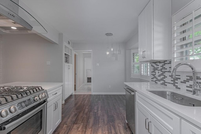 3336 Whitehall Dr, Dallas, TX 75229 - kitchen featuring a sink, appliances with stainless steel finishes, wall chimney range hood, and light countertops