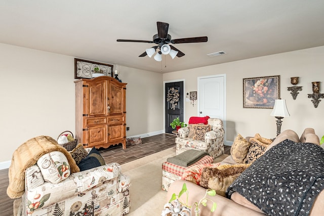 living room featuring a ceiling fan, wood finished floors, baseboards, and visible vents