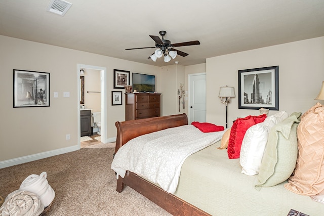 bedroom with ensuite bath, baseboards, visible vents, ceiling fan, and carpet