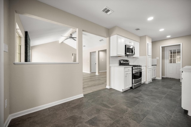 kitchen featuring baseboards, appliances with stainless steel finishes, visible vents, and light countertops