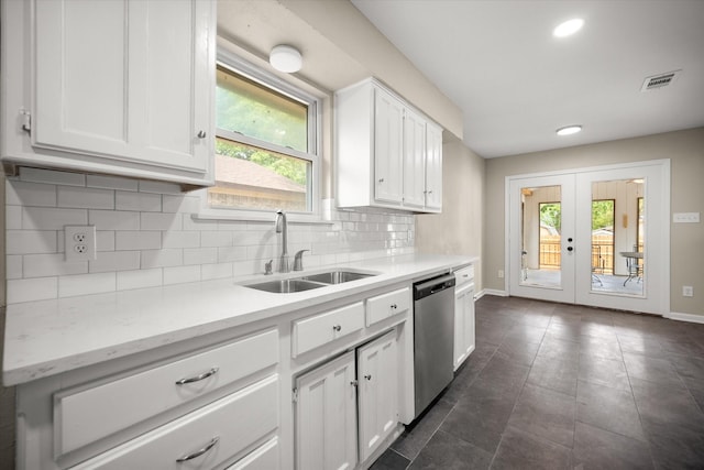 kitchen featuring dishwasher, visible vents, a healthy amount of sunlight, a sink, and white cabinetry