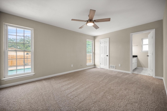 unfurnished bedroom with visible vents, baseboards, and multiple windows