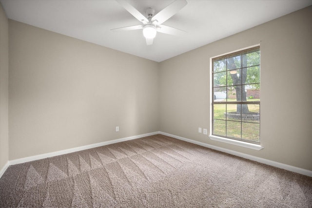 empty room with ceiling fan, baseboards, and carpet