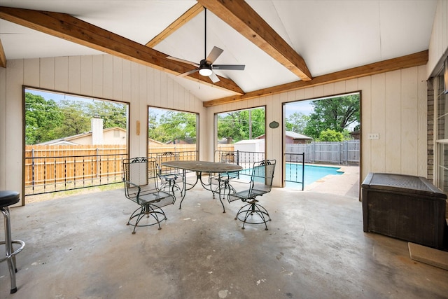 sunroom / solarium featuring beamed ceiling