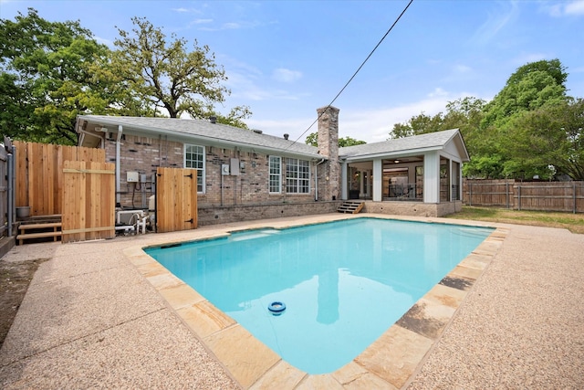 view of pool with a patio area, a fenced backyard, and a fenced in pool