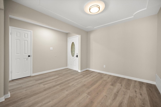 entryway with baseboards and wood finished floors