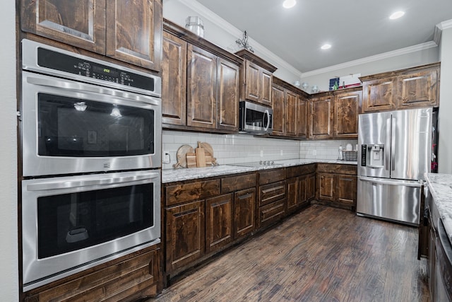 kitchen with crown molding, tasteful backsplash, appliances with stainless steel finishes, dark wood-style floors, and dark brown cabinets