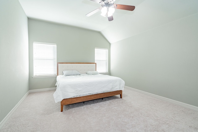 bedroom featuring baseboards, ceiling fan, vaulted ceiling, and carpet