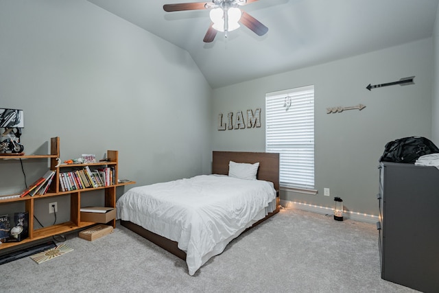 carpeted bedroom featuring baseboards, lofted ceiling, and a ceiling fan