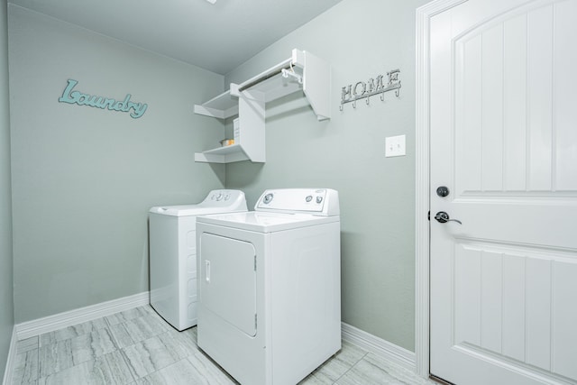 laundry room featuring baseboards, washing machine and dryer, and laundry area