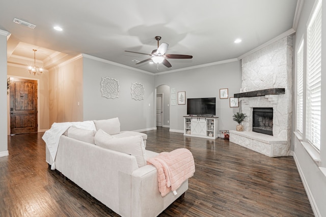 living room featuring visible vents, arched walkways, crown molding, and dark wood-type flooring