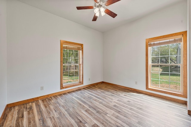 unfurnished room featuring light wood finished floors, baseboards, and ceiling fan