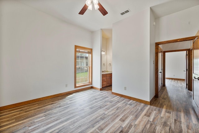 unfurnished bedroom featuring wood finished floors, baseboards, and visible vents