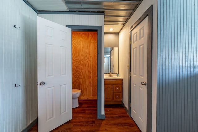 bathroom featuring wood finished floors, toilet, and vanity