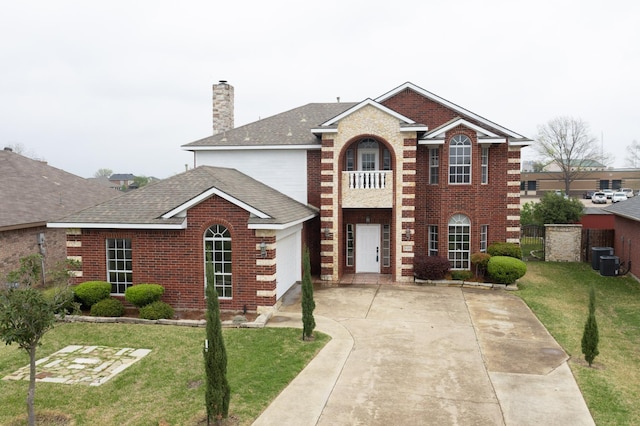 3120 Cantura Dr, Mesquite, TX 75181 - colonial home with brick siding, a front yard, a chimney, and a garage