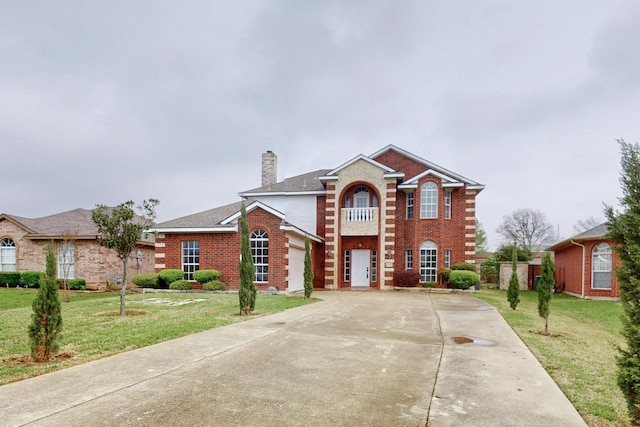 3120 Cantura Dr, Mesquite, TX 75181 - georgian-style home with concrete driveway, a chimney, a front yard, and brick siding