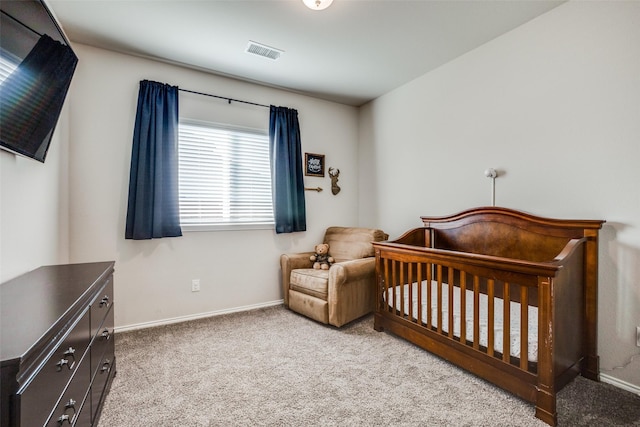 carpeted bedroom featuring baseboards and visible vents