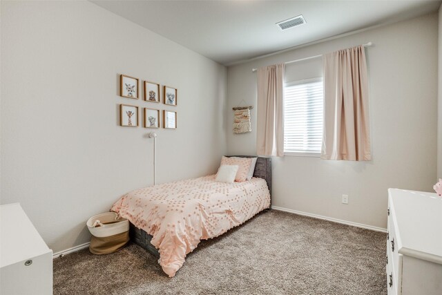 carpeted bedroom featuring baseboards and visible vents