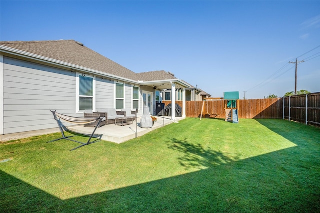 view of yard with a fenced backyard, a patio, and a playground