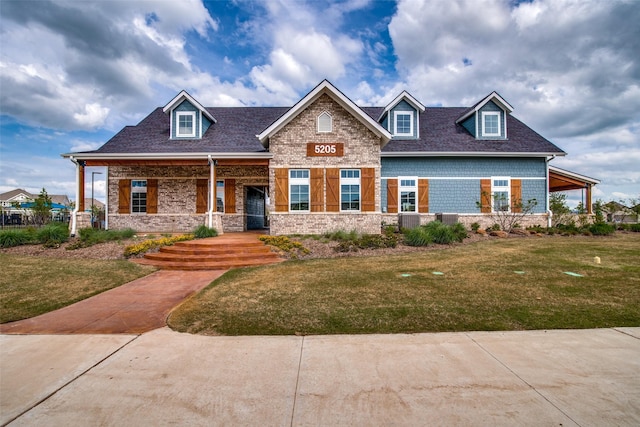 craftsman-style home featuring covered porch and a front yard