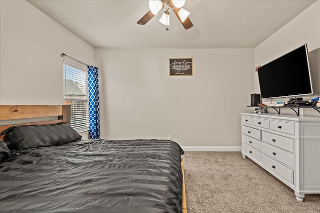 bedroom with light carpet, ceiling fan, and baseboards