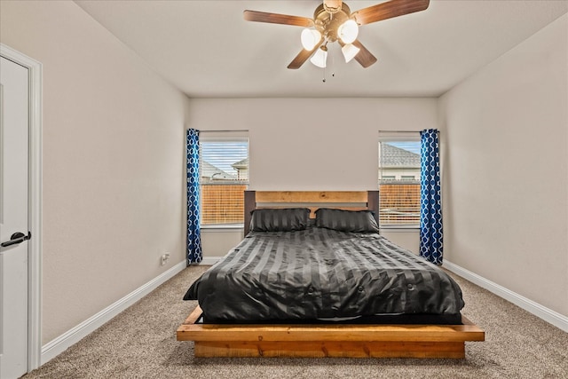 carpeted bedroom featuring baseboards and a ceiling fan