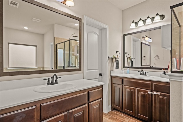 full bathroom featuring visible vents, a stall shower, and vanity