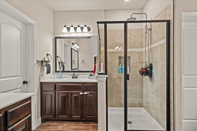 bathroom featuring a shower stall and vanity