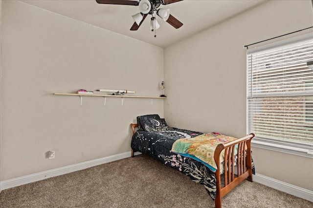 bedroom featuring carpet floors, baseboards, multiple windows, and a ceiling fan