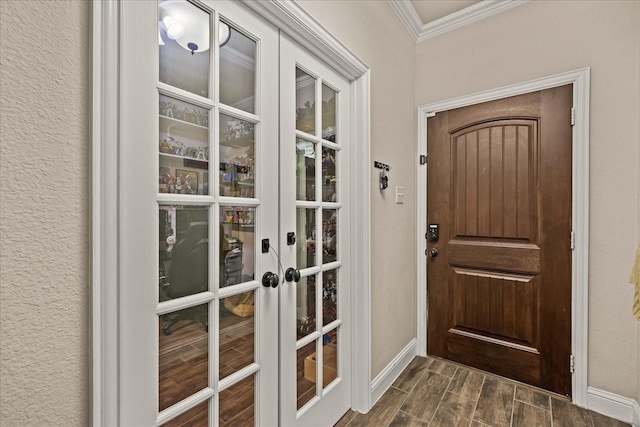doorway to outside with crown molding, french doors, baseboards, and wood tiled floor
