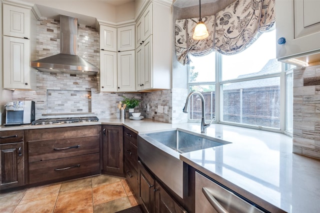 1179 Marquette Dr, Frisco, TX 75033 - kitchen with wall chimney exhaust hood, a sink, appliances with stainless steel finishes, light countertops, and dark brown cabinets