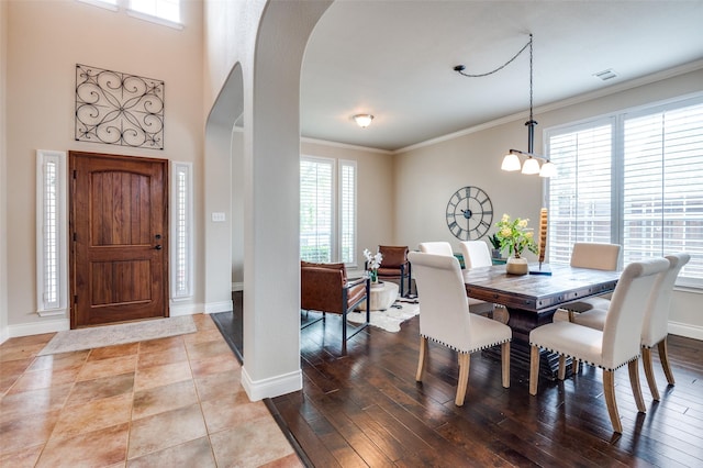 1179 Marquette Dr, Frisco, TX 75033 - dining area with arched walkways, crown molding, baseboards, and wood finished floors