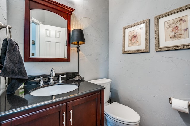 1179 Marquette Dr, Frisco, TX 75033 - bathroom featuring toilet, vanity, and a textured wall