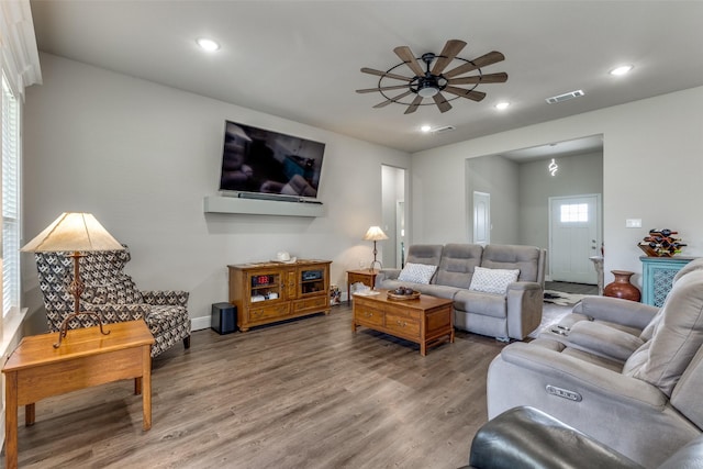 living room featuring wood finished floors, visible vents, a ceiling fan, and recessed lighting