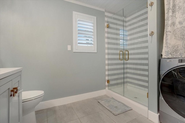 bathroom with tile patterned flooring, toilet, baseboards, a shower stall, and washer / dryer