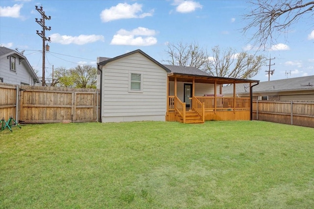 back of house with a fenced backyard and a lawn