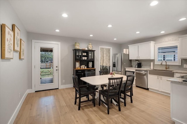 dining area with a wealth of natural light, baseboards, light wood-style floors, and recessed lighting