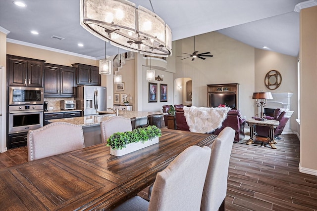 208 Equestrian Ln, Hickory Creek, TX 75065 - dining area with dark wood-type flooring, ceiling fan, arched walkways, recessed lighting, and crown molding