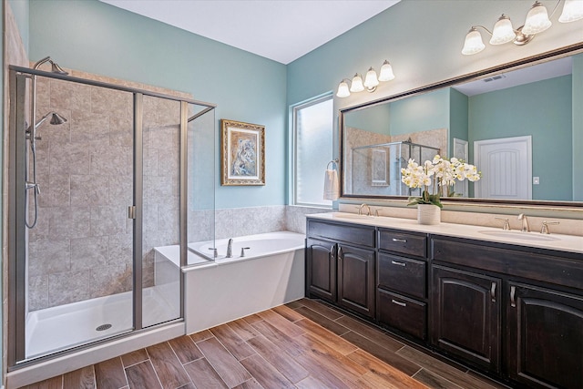 208 Equestrian Ln, Hickory Creek, TX 75065 - bathroom featuring a garden tub, a shower stall, double vanity, and wood finished floors