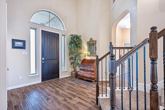 208 Equestrian Ln, Hickory Creek, TX 75065 - entrance foyer with a high ceiling, wood finish floors, stairway, and arched walkways